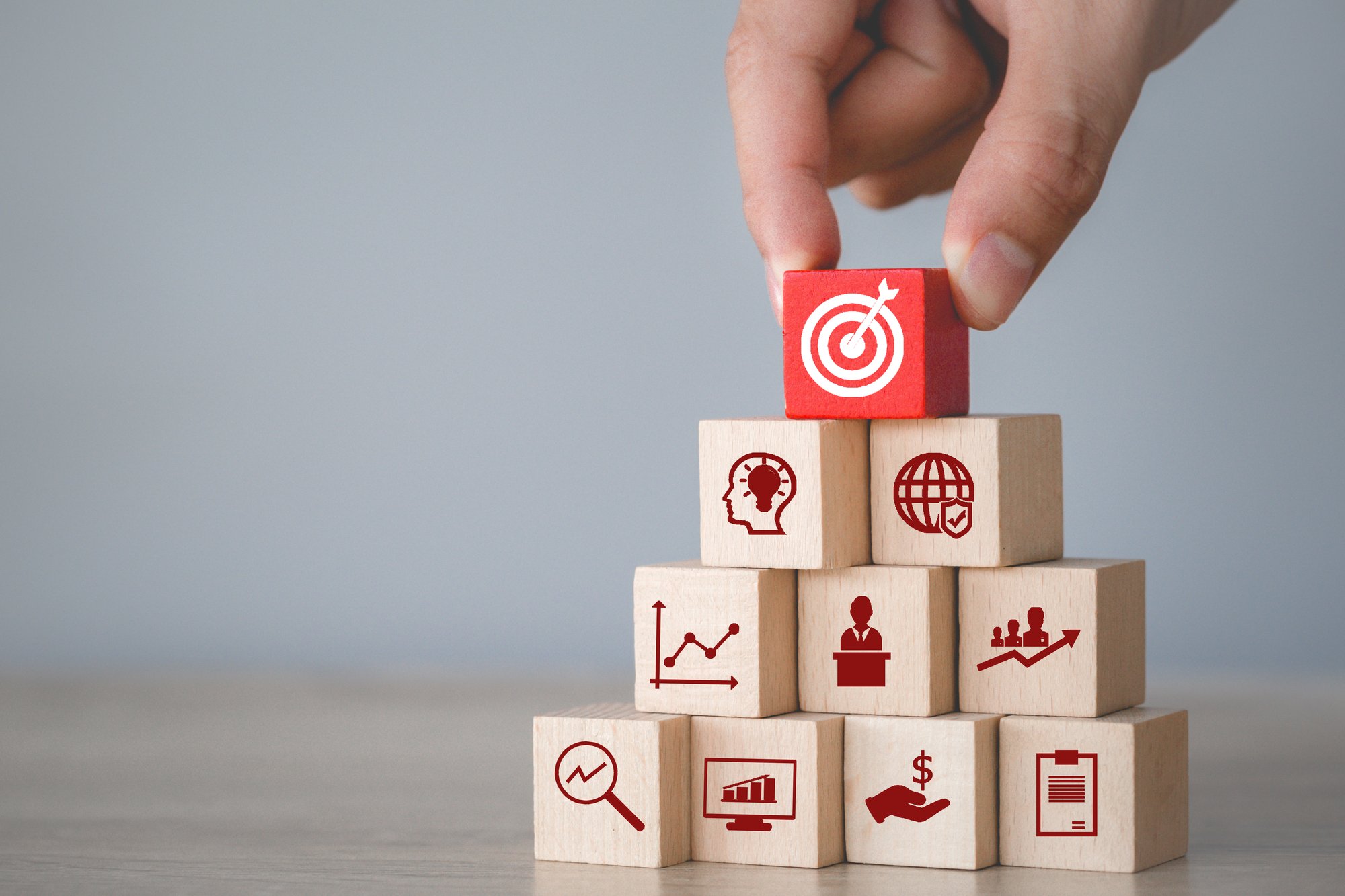 hand-arranging-wood-block-stacking-with-icon-arrow-business-targeting-business-concept